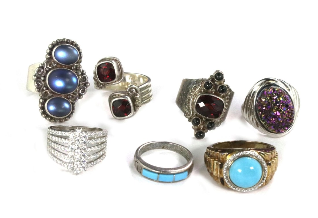 Vintage Lot of 7 Sterling Silver Rings with Turquoise Onyx Garnet: Vintage Lot of 7 Sterling Silver Rings with Turquoise Onyx Garnet This vintage lot features seven stunning rings, each crafted from high-quality sterling silver, with some accentuated by yellow gold. 