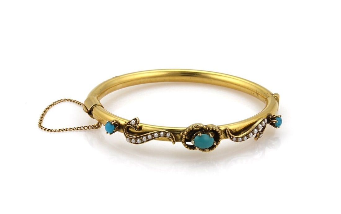 Vintage 14k Yellow Gold Bangle Bracelet with Turquoise and Seed Pearls: Vintage 14k Yellow Gold Bangle Bracelet with Turquoise and Seed Pearls A vintage estate fancy bangle bracelet crafted in 14k yellow gold, featuring turquoise gemstones accented with seed pearls. It ha