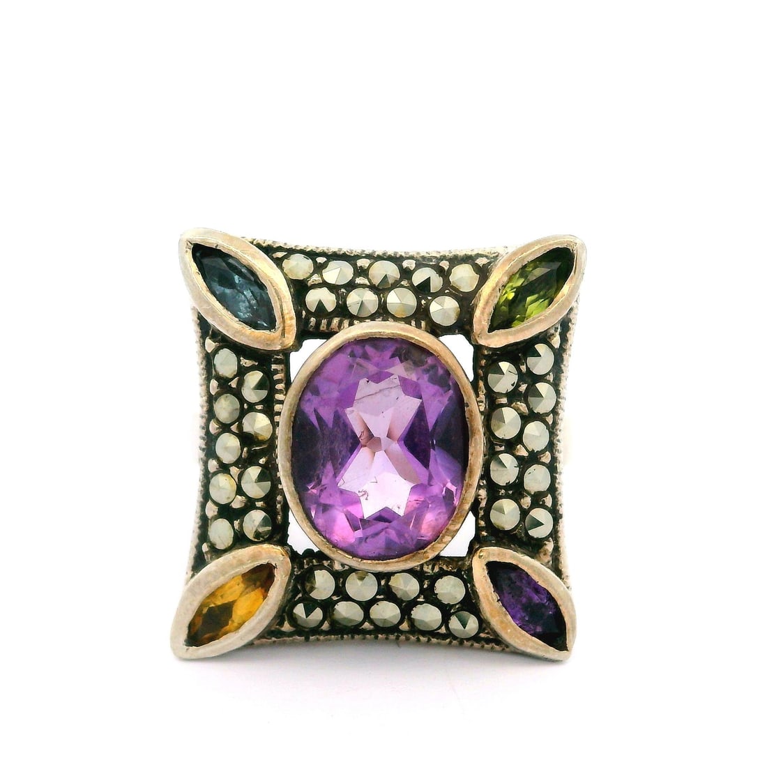 Vintage Sterling Silver Cocktail Ring with Amethyst and Marcasite: Vintage Sterling Silver Cocktail Ring with Amethyst and Marcasite This stunning vintage cocktail ring showcases a beautiful arrangement of genuine gemstones set in sterling silver. The centerpiece fea