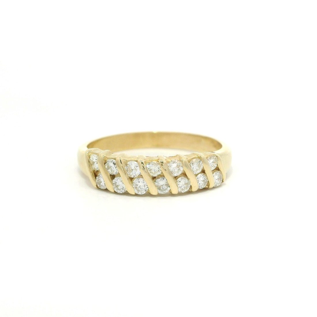 14k Yellow Gold 0.35ctw Diamond Stackable Band Ring: 14k Yellow Gold 0.35ctw Diamond Stackable Band Ring This elegant 14k yellow gold band ring features a stunning diagonal channel set with fourteen natural diamonds. The brilliant cut diamonds, totaling