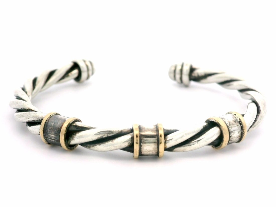 Estate Sterling Silver Twisted Cable Cuff Bracelet with Yellow Gold Accents: Estate Sterling Silver Twisted Cable Cuff Bracelet with Yellow Gold Accents This elegant cuff bracelet features a stunning design crafted from .925 sterling silver with yellow gold accents. The twiste