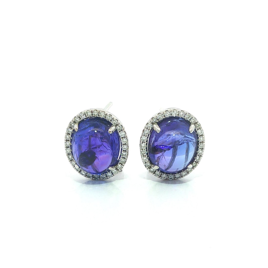 GIA Tanzanite Diamond Frame Earrings 18k White Gold Oval Cabochon: GIA Tanzanite Diamond Frame Earrings 18k White Gold Oval Cabochon These elegant earrings are crafted from solid 18k white gold and feature two natural blue-violet tanzanite gemstones in oval double ca