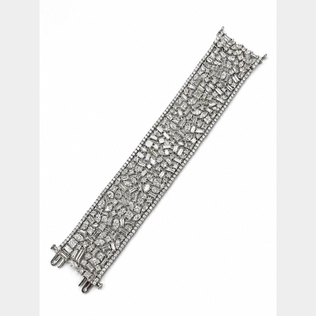 68.70 Ct Diamond Bracelet in Platinum and 18K White Gold: 68.70 Ct Diamond Bracelet in Platinum and 18K White Gold A pre-owned bracelet crafted in platinum and 18K white gold, set with diamonds. It weighs 122.3 grams and measures 7.5 x 1.35 inches. The brace