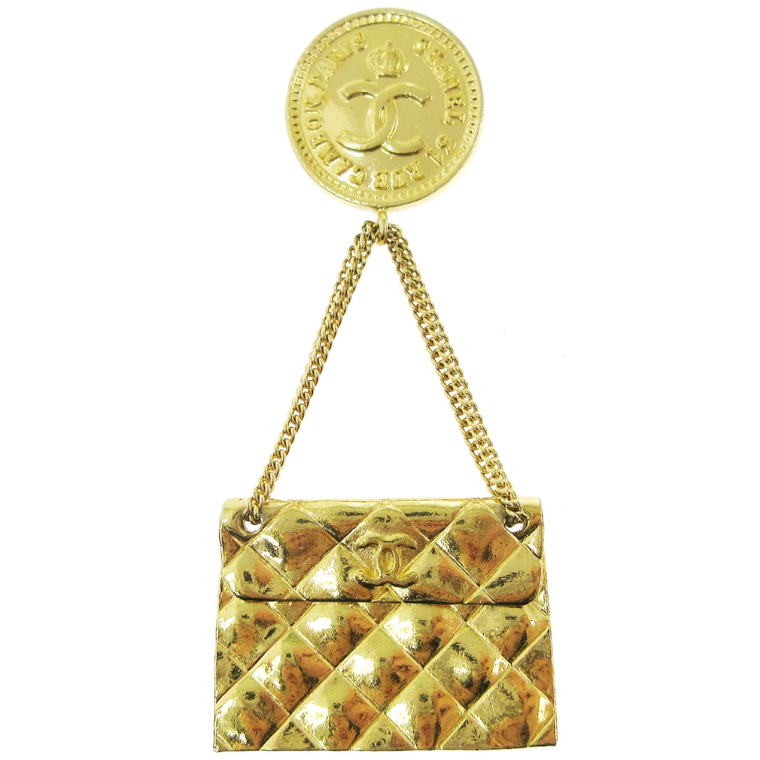 Chanel quilted bag motif brooch pin gold tone: Chanel quilted bag motif brooch pin gold tone Gold-tone brooch pin in a quilted bag motif with logo detailing. This Chanel piece features a decorative handbag-inspired design and shows reasonable wear