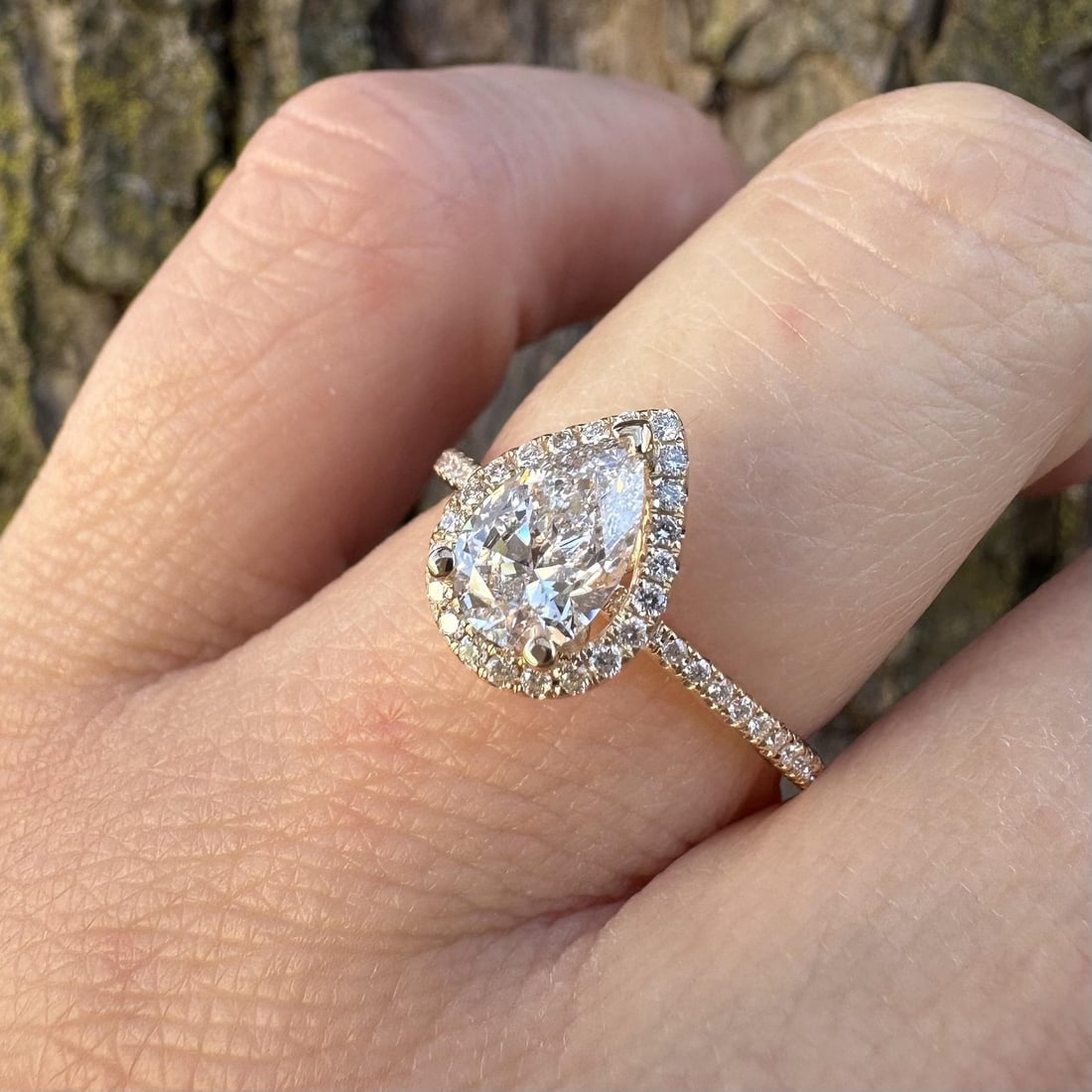 Pear Shape Diamond Halo Engagement Ring in 14k Yellow Gold with GIA Certificate: Pear Shape Diamond Halo Engagement Ring in 14k Yellow Gold with GIA Certificate This engagement ring features a natural pear-cut diamond at its center, surrounded by a halo of round brilliant-cut diam