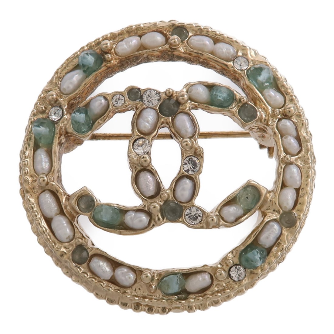 Metal CC Brooch in White Green Gold by CHANEL: Metal CC Brooch in White Green Gold by CHANEL CHANEL CC brooch in metal with a gold, green, and white colorway. The item is described as in reasonable wear and tear condition and comes with no accesso