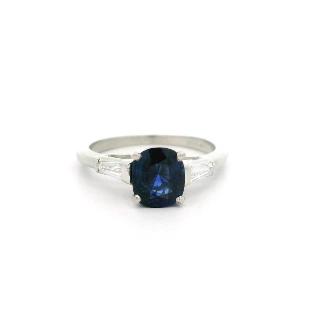 Vintage 18K White Gold GIA 1.26ctw Blue Sapphire Diamond Ring: Vintage 18K White Gold GIA 1.26ctw Blue Sapphire Diamond Ring This vintage classic ring showcases a stunning 1.26ctw cushion sapphire and baguette diamond design, crafted in solid 18k white gold. The 
