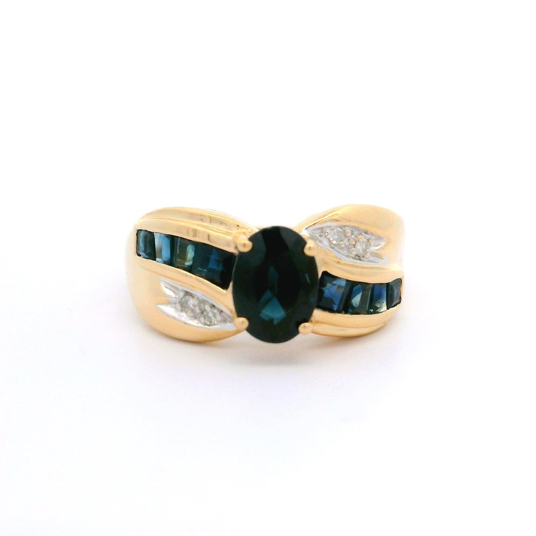 14k Yellow Gold Cocktail Ring with Blue Sapphire and Diamond Accents: 14k Yellow Gold Cocktail Ring with Blue Sapphire and Diamond Accents This stunning cocktail ring features a prominent natural genuine sapphire in an oval brilliant cut, prong set to showcase its deep 
