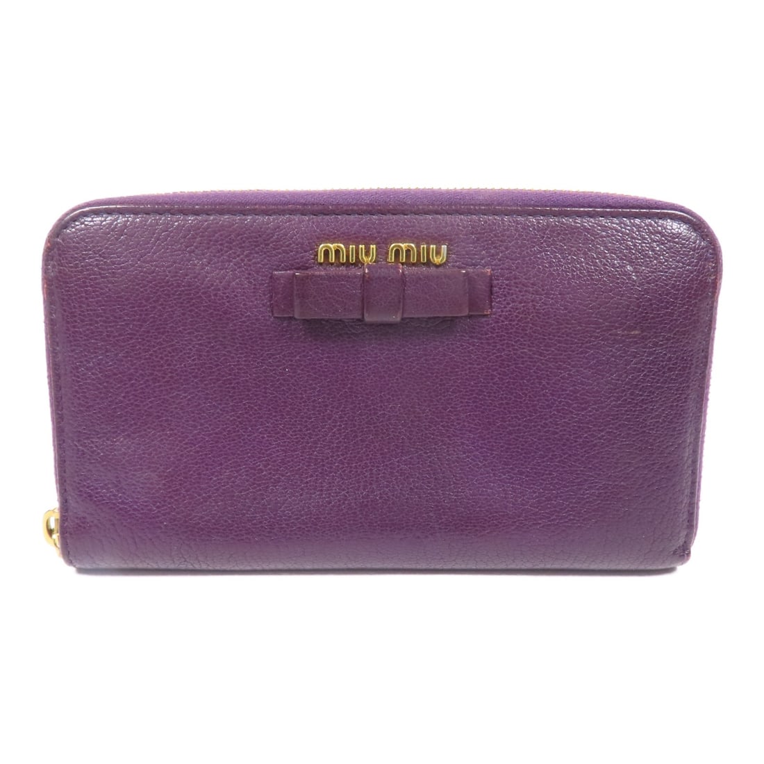 Miu Miu Purple Calfskin Long Wallet Gold Tone Hardware: Miu Miu Purple Calfskin Long Wallet Gold Tone Hardware Long wallet in calfskin leather with a purple color and gold-tone hardware. It features two open pockets, two wallet compartments, eight card slo