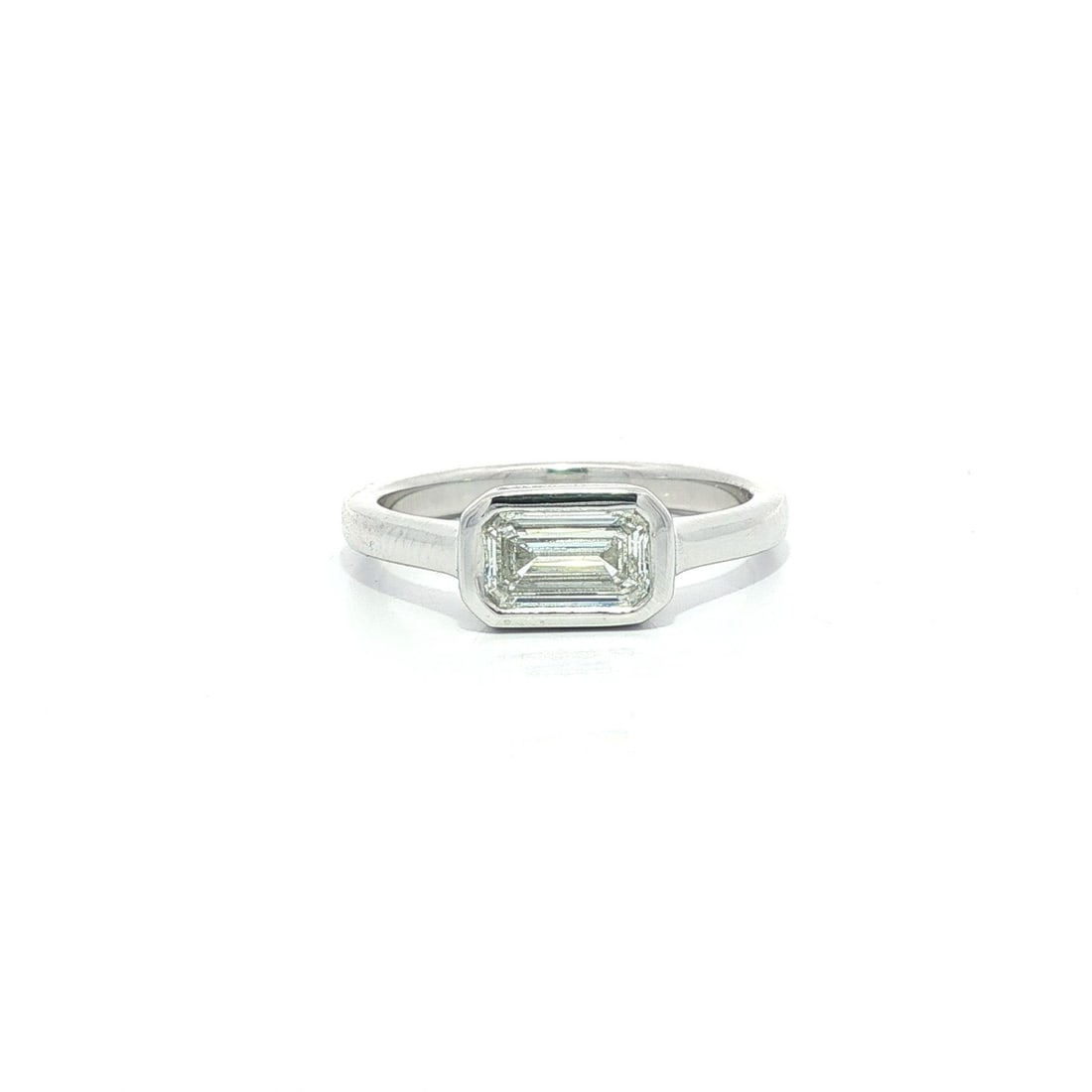 Platinum Diamond Solitaire Ring 0.70ct GIA D VS1 Emerald Cut Bezel Set: Platinum Diamond Solitaire Ring 0.70ct GIA D VS1 Emerald Cut Bezel Set This un-used platinum solitaire ring features a 0.70 carat natural emerald cut diamond, bezel set in an east-west orientation. Th