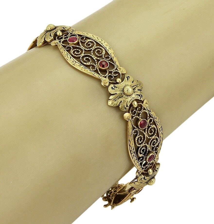 18k Yellow Gold Open Floral Link Bracelet with Red Stones: 18k Yellow Gold Open Floral Link Bracelet with Red Stones Antique long floral bracelet crafted in 18k yellow gold with open link construction and vivid red stone accents. The design features detailed 