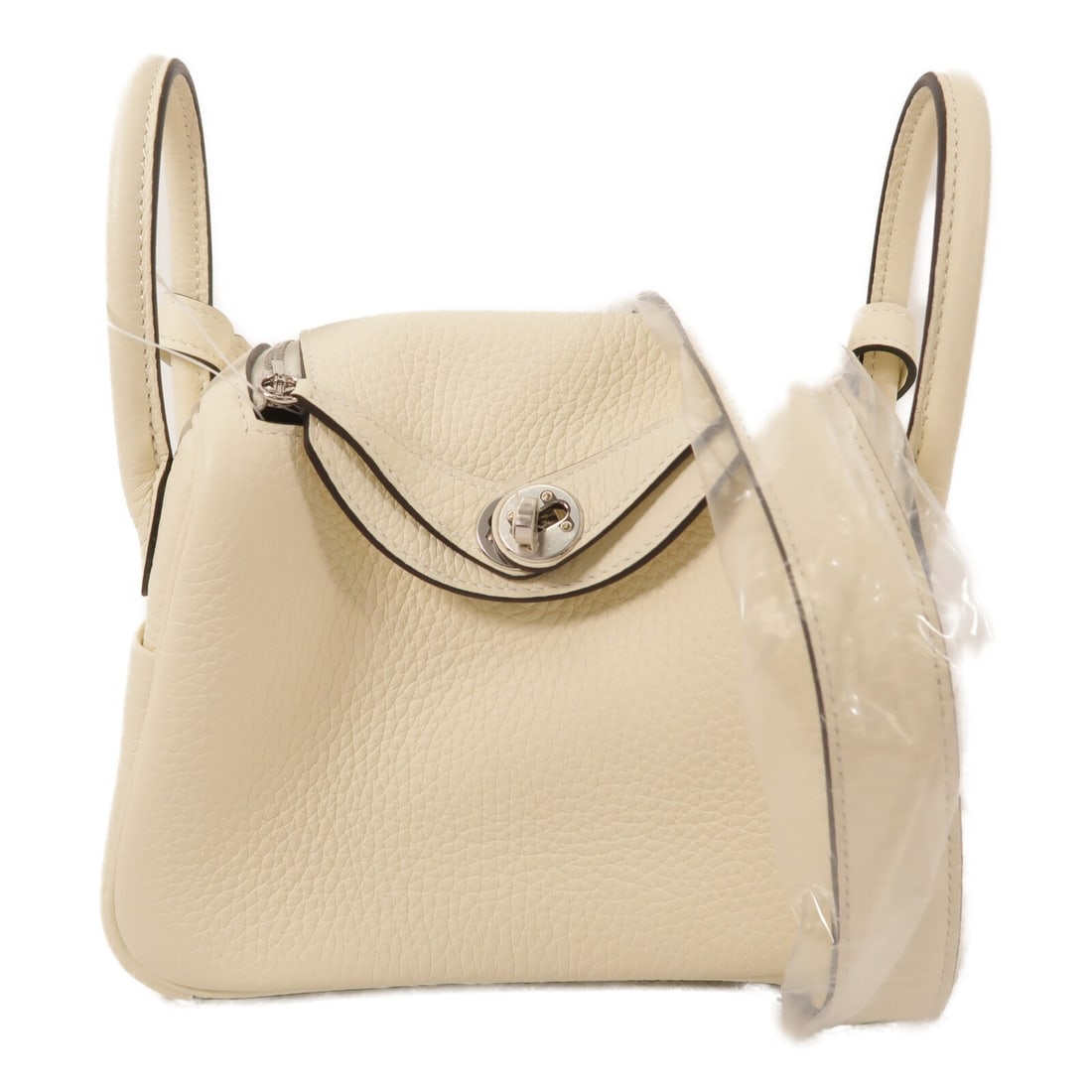 Hermes Mini Lindy 2Way Shoulder Handbag White Taurillon Clemence PHW: Hermes Mini Lindy 2Way Shoulder Handbag White Taurillon Clemence PHW A Hermes Mini Lindy 2Way shoulder bag in WhitexCream, crafted from Taurillon Clemence and calfskin (cowhide). It features a 20 cm w