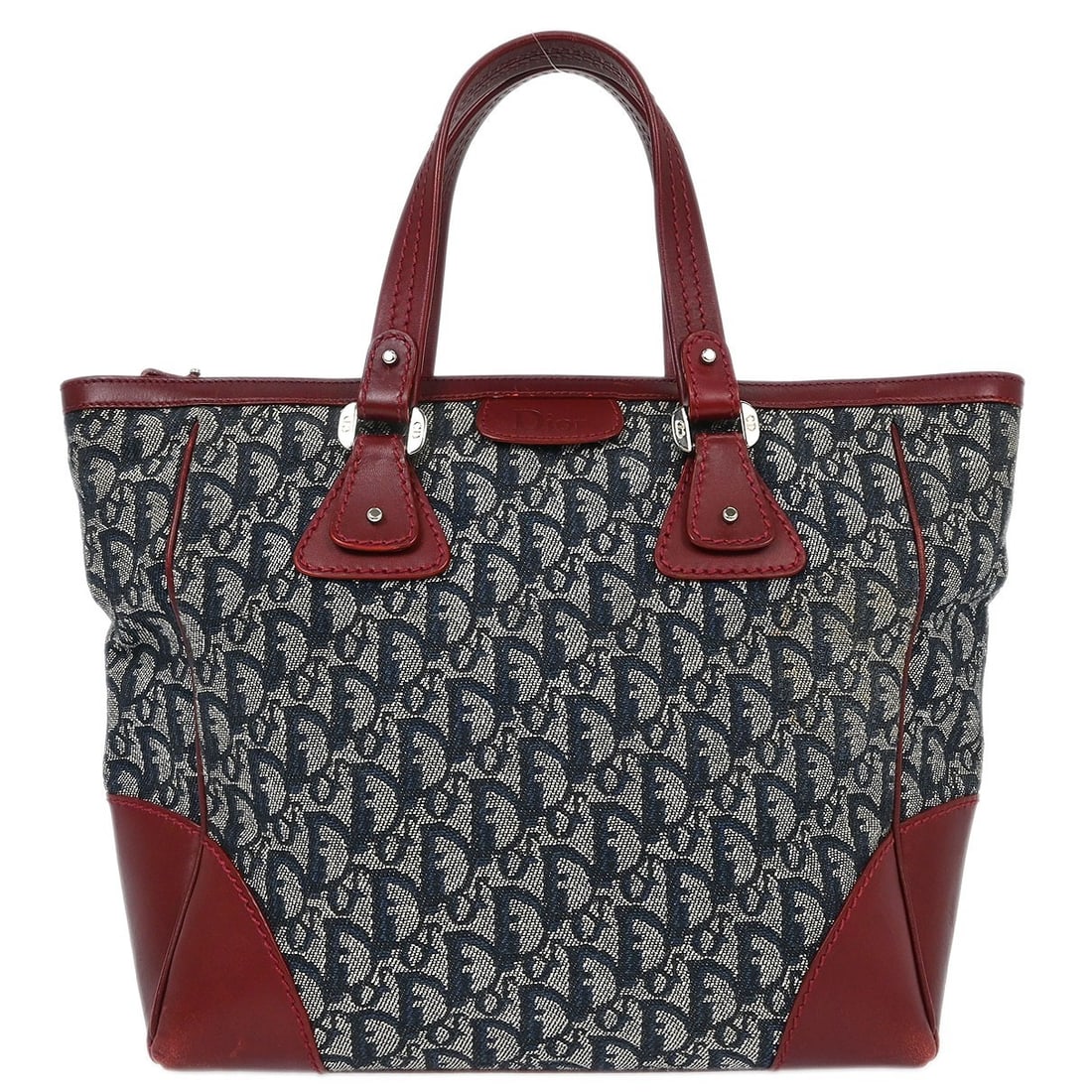 Dior Trotter Medium Tote in Navy and Bordeaux Canvas Leather: Dior Trotter Medium Tote in Navy and Bordeaux Canvas Leather Christian Dior Trotter tote bag in navy canvas and leather with bordeaux accents. This medium tote features double handles, a zip closure,