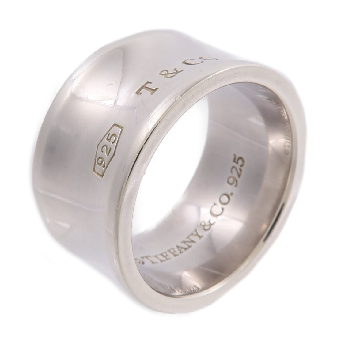 Tiffany and Co Preceptor Wide Band Ring Sterling Silver 925 Size 8.25: Tiffany and Co Preceptor Wide Band Ring Sterling Silver 925 Size 8.25 Wide sterling silver ring in size 8.25, identified as the Preceptor Ring style. It is described as silver with no main stone and i