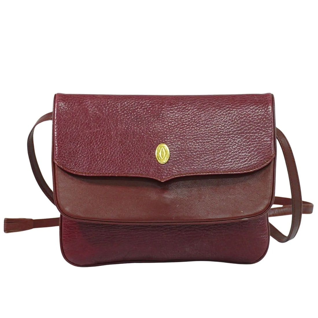 Cartier Must de Cartier Burgundy Leather Shoulder Bag: Cartier Must de Cartier Burgundy Leather Shoulder Bag The Must de Cartier Shoulder Bag is crafted from burgundy leather and designed for women. This bag features a sleek silhouette and is made in Ital