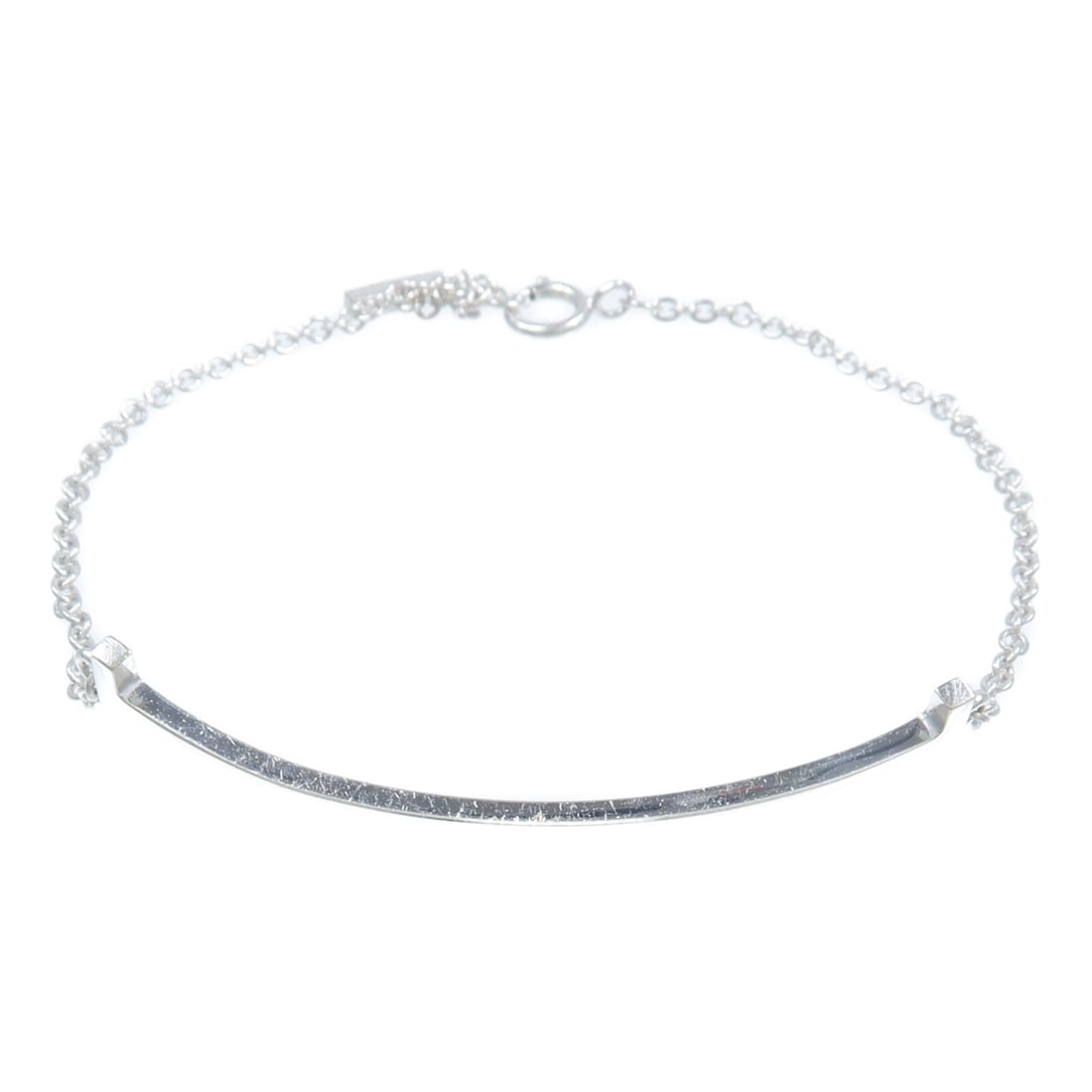 18K White Gold Tiffany Co Smile Bracelet: 18K White Gold Tiffany Co Smile Bracelet Tiffany & Co. Smile Bracelet in 18K white gold. The piece features a silver-toned appearance and a smile motif measuring 40 mm wide by 5 mm high. It is sized f