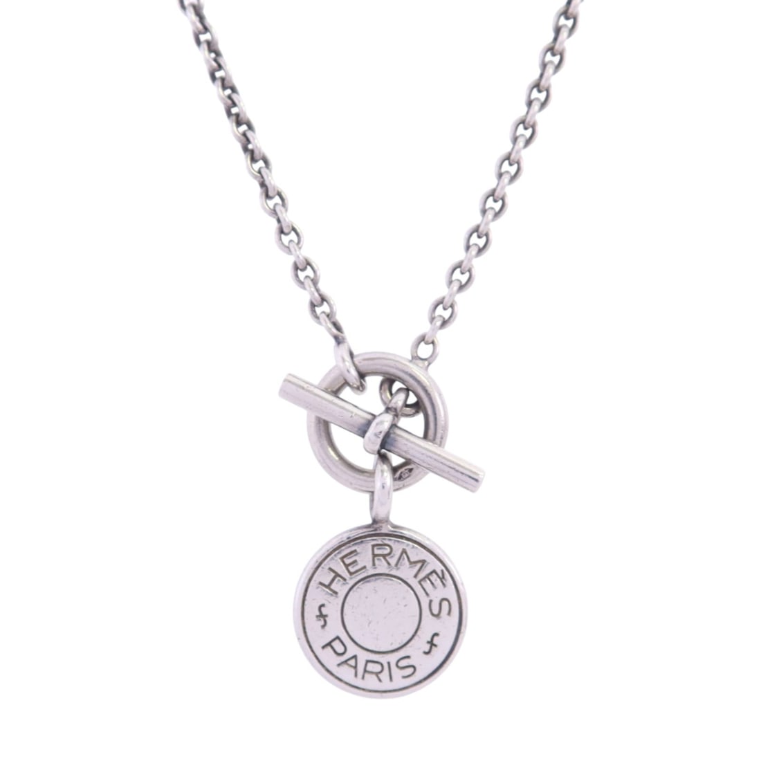 Hermes Amulettes Ex-Libris 925 Sterling Silver Necklace: Hermes Amulettes Ex-Libris 925 Sterling Silver Necklace Hermes PHW Amulettes Ex-Libris Necklace in 925 sterling silver. This women's necklace features a silver finish and an Ex-Libris motif. It comes 