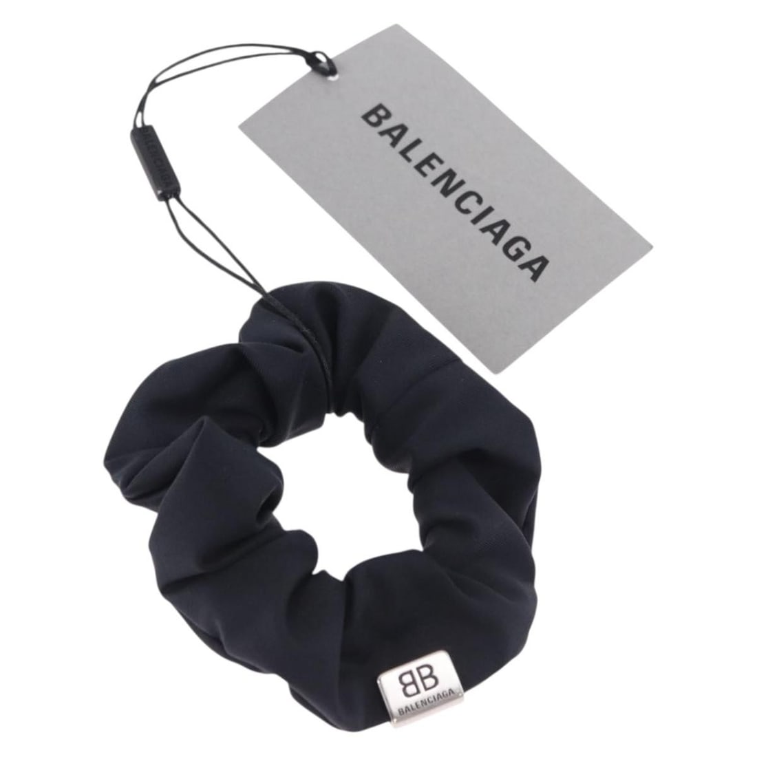 Balenciaga Shush Black Nylon Hair Tie with Box: Balenciaga Shush Black Nylon Hair Tie with Box Balenciaga Shush hair tie in black nylon, made in Italy. It comes with the item box and is described as being in excellent condition, with no remarkable 