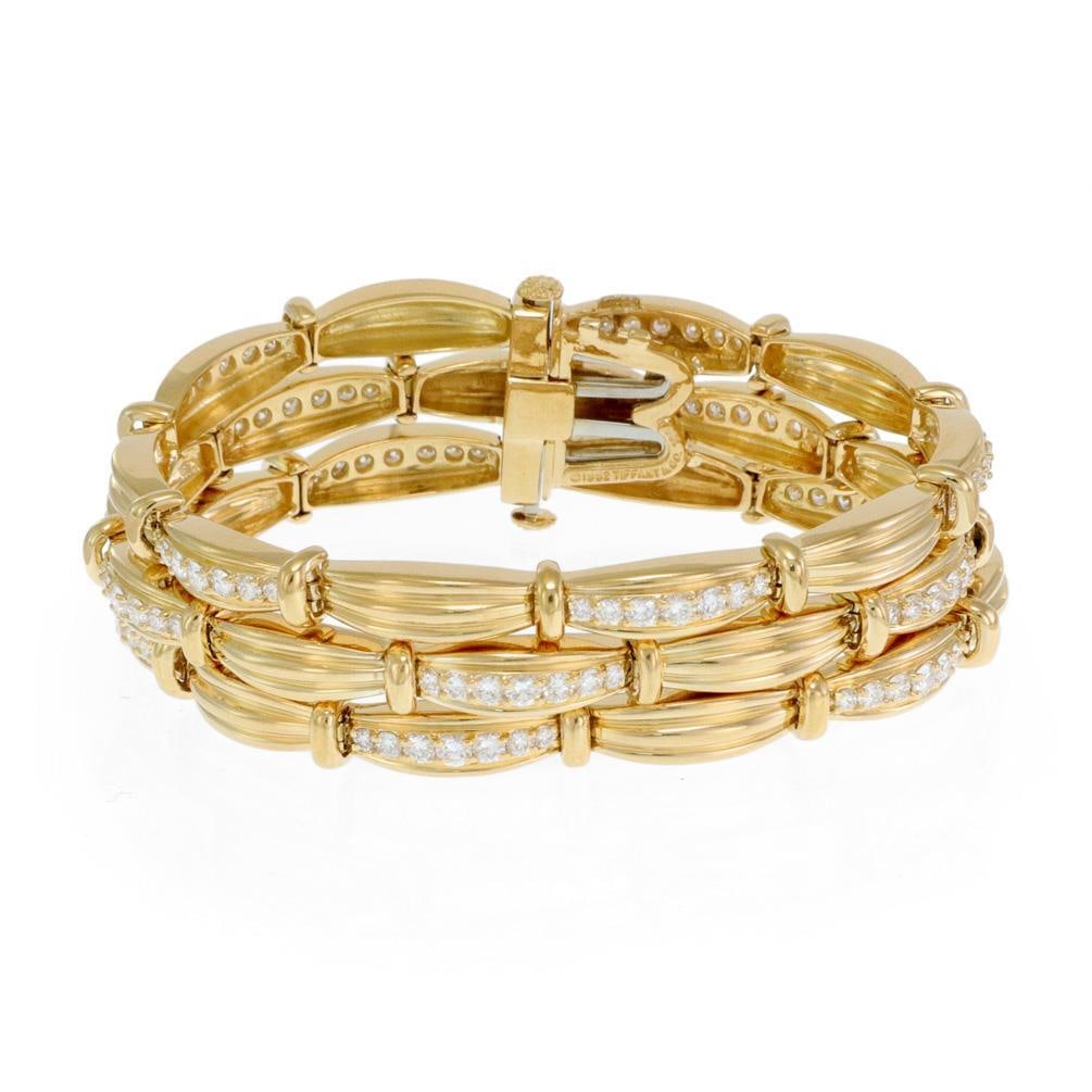 Tiffany Co Signature 18k Yellow Gold Diamond Triple Row Link Bracelet: Tiffany Co Signature 18k Yellow Gold Diamond Triple Row Link Bracelet Authentic Tiffany & Co. Signature bracelet crafted in 18k yellow gold. This triple-row link design features long curved bar links 