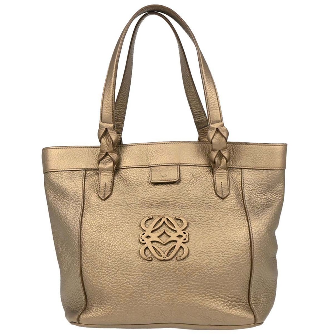 Loewe medium leather tote handbag in gold with dust bag: Loewe medium leather tote handbag in gold with dust bag A medium Loewe tote handbag made in Spain, crafted from leather in a gold exterior color. It features double handles, inner pockets, and one ins