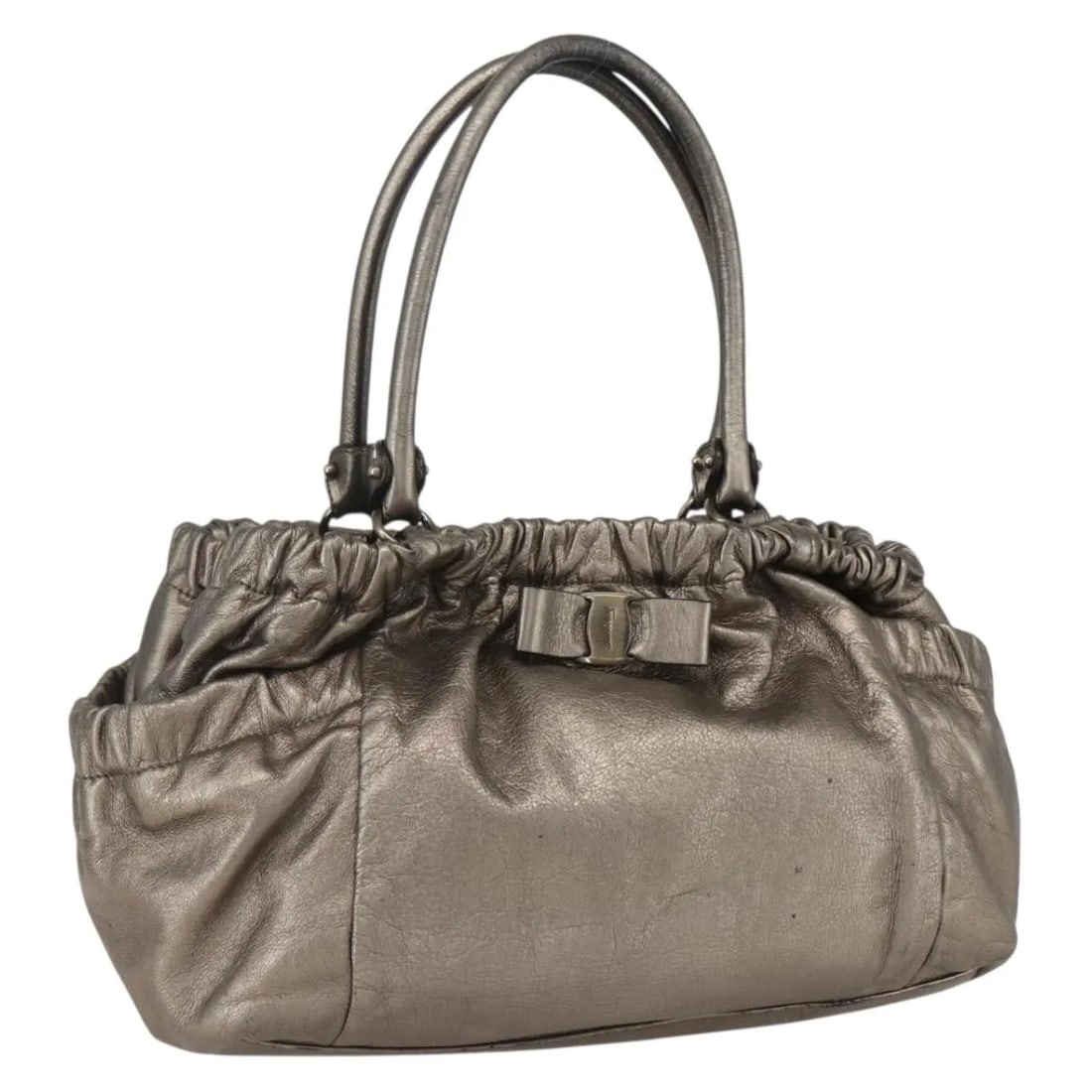 Leather Vala Handbag by Salvatore Ferragamo in Gold: Leather Vala Handbag by Salvatore Ferragamo in Gold This Salvatore Ferragamo Vala handbag for women features gold leather construction with metal fittings. It shows signs of wear including surface def