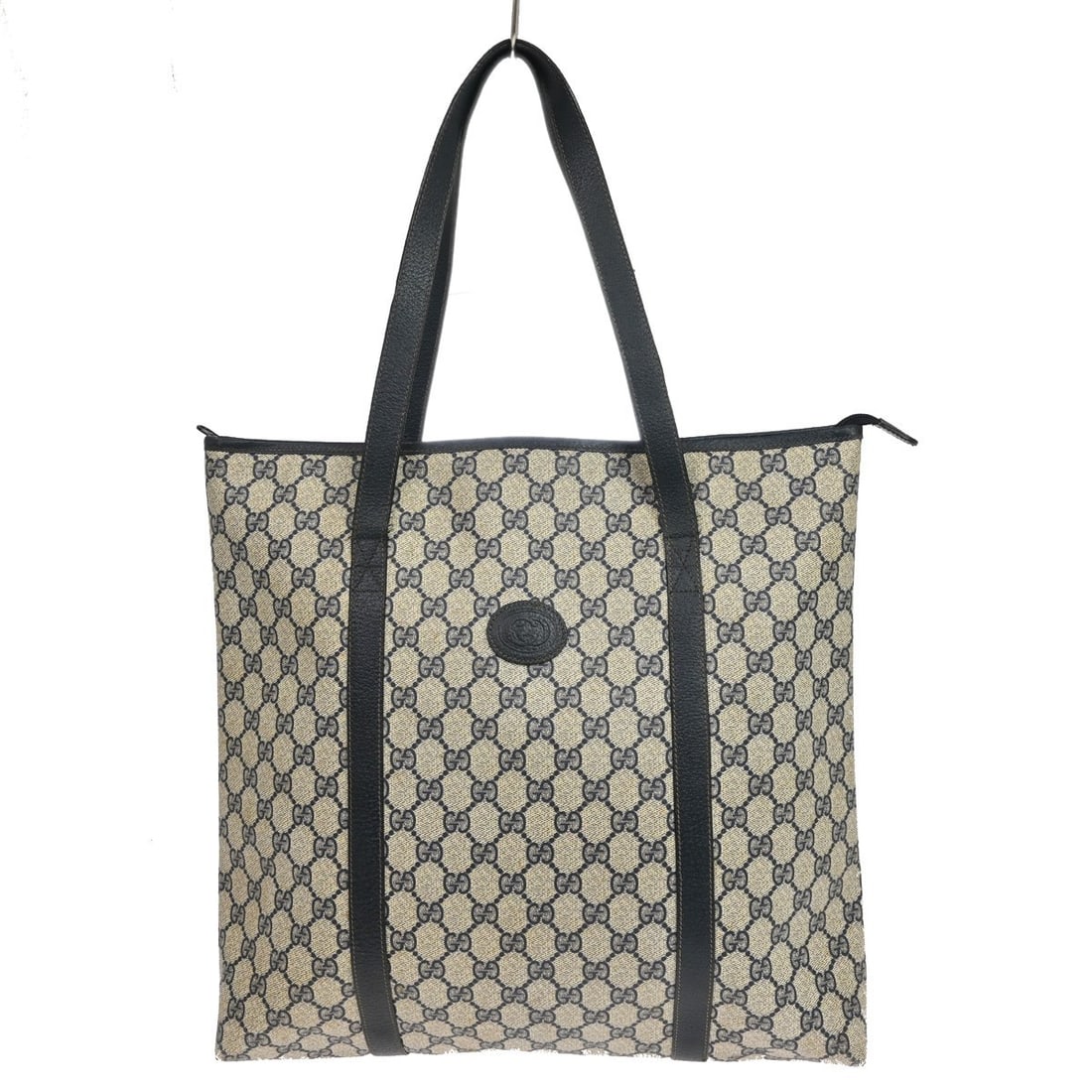 Gucci GG Large Navy PVC Canvas Leather Zip Tote Bag: Gucci GG Large Navy PVC Canvas Leather Zip Tote Bag Vintage Gucci GG tote handbag in navy and beige with a zip closure and leather handles. The exterior shows stains on the PVC canvas and scuffing at 