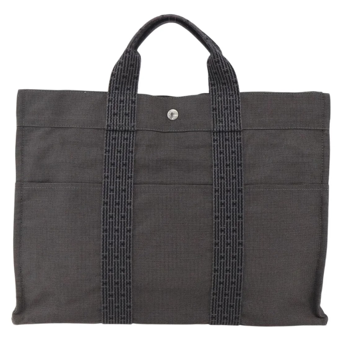 Fourre-tout Herline gray canvas tote bag by Hermes: Fourre-tout Herline gray canvas tote bag by Hermes The Hermes Fourre-tout Herline is a women's tote crafted from gray canvas. This bag features a spacious interior and sturdy handles, with signs of us