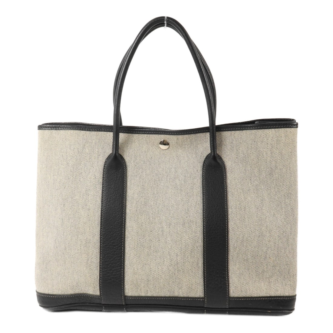 Hermes Garden Party PM Canvas Tote Noir Black PHW: Hermes Garden Party PM Canvas Tote Noir Black PHW Hermes Garden Party PM handbag in canvas, presented in Noir Black. This bag features a hook button closure, a handle drop of 34.5 cm, and comes with s