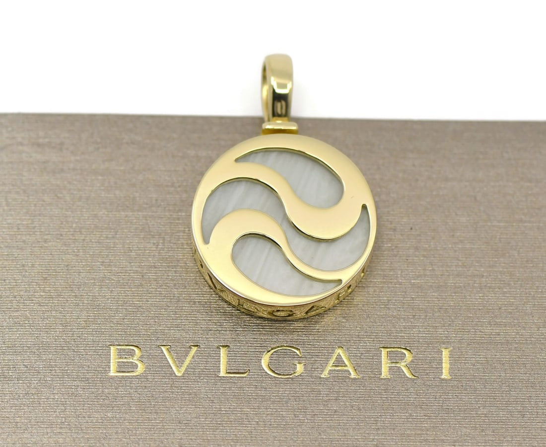 Bvlgari BVLGARI BVLGARI 18K Yellow Gold Mother of Pearl Pendant: Bvlgari BVLGARI BVLGARI 18K Yellow Gold Mother of Pearl Pendant This Bulgari Optical Illusion pendant is crafted from 18K yellow gold and features a striking design from the BVLGARI BVLGARI collection