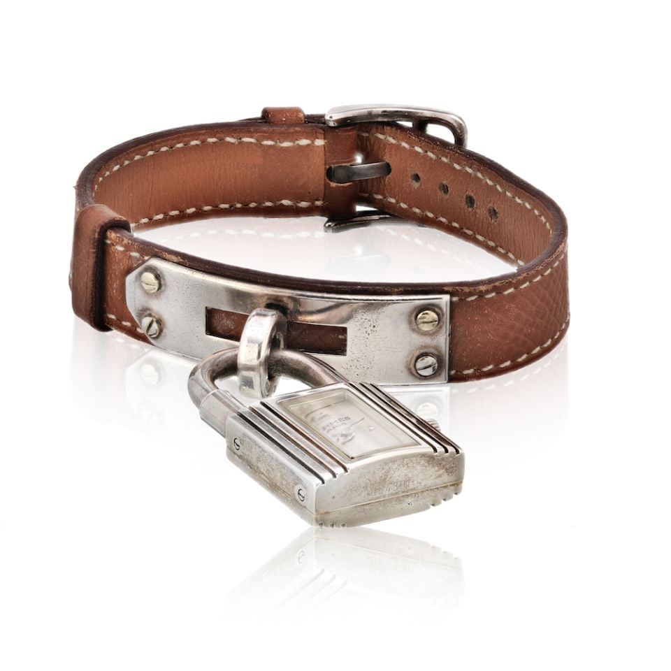 Hermes Vintage Stainless Steel Mother of Pearl Dial Watch: Hermes Vintage Stainless Steel Mother of Pearl Dial Watch This vintage Hermes watch features a stunning mother of pearl dial framed in durable stainless steel. The elegant brown leather strap compleme
