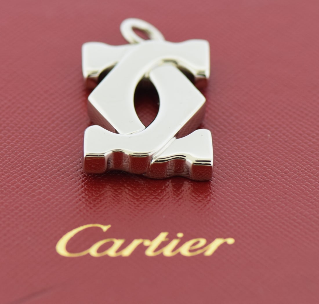Heart Shaped Stainless Steel Key Ring by Cartier with Box: Heart Shaped Stainless Steel Key Ring by Cartier with Box This Cartier key ring features a heart-shaped design crafted from stainless steel with a silver-tone finish. Suitable for unisex use, it offer