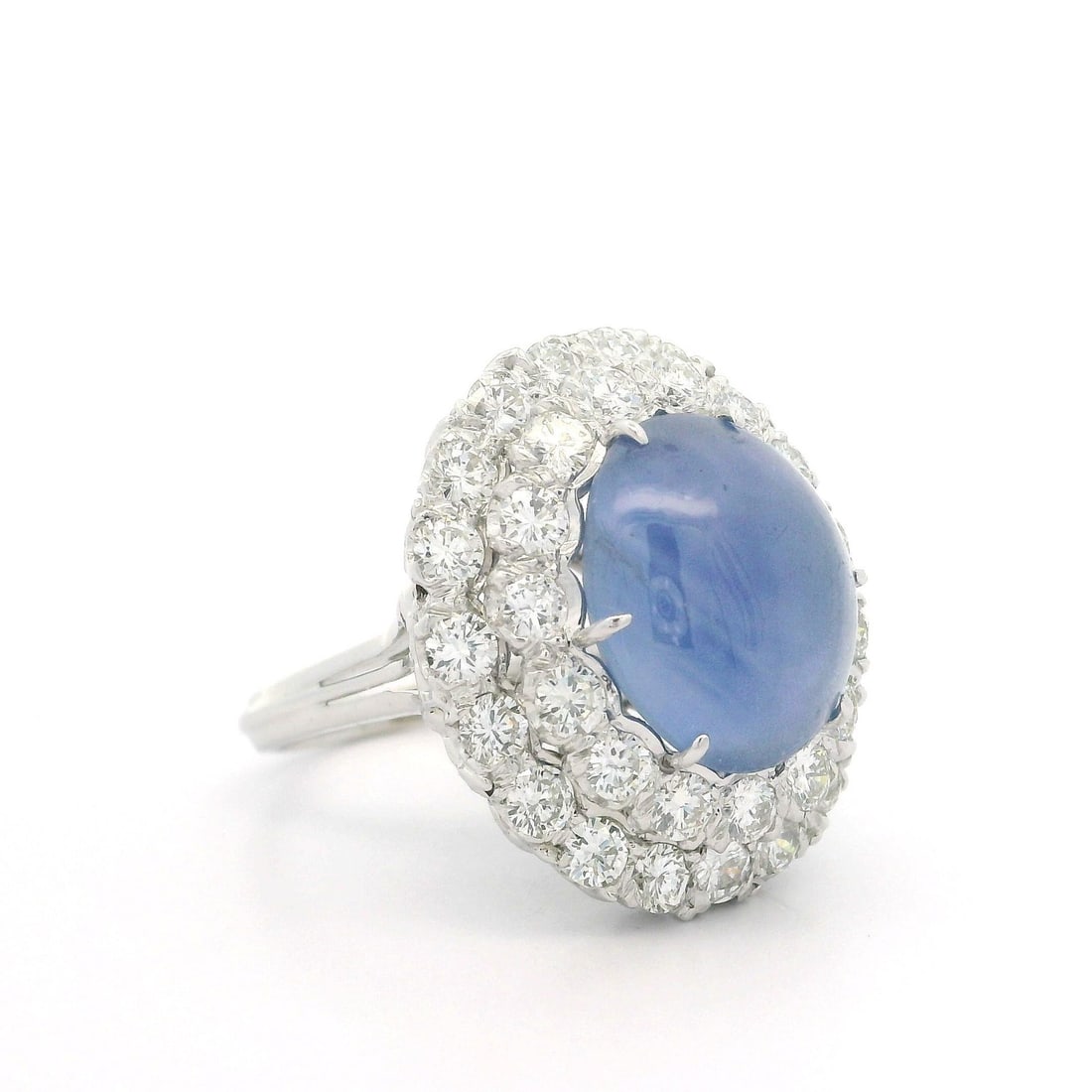 Women's Cocktail Ring with GIA Star Sapphire and Diamond Double Halo in White Gold: Women's Cocktail Ring with GIA Star Sapphire and Diamond Double Halo in White Gold This vintage cocktail ring features a natural blue star sapphire from Sri Lanka, weighing approximately 10 carats, se