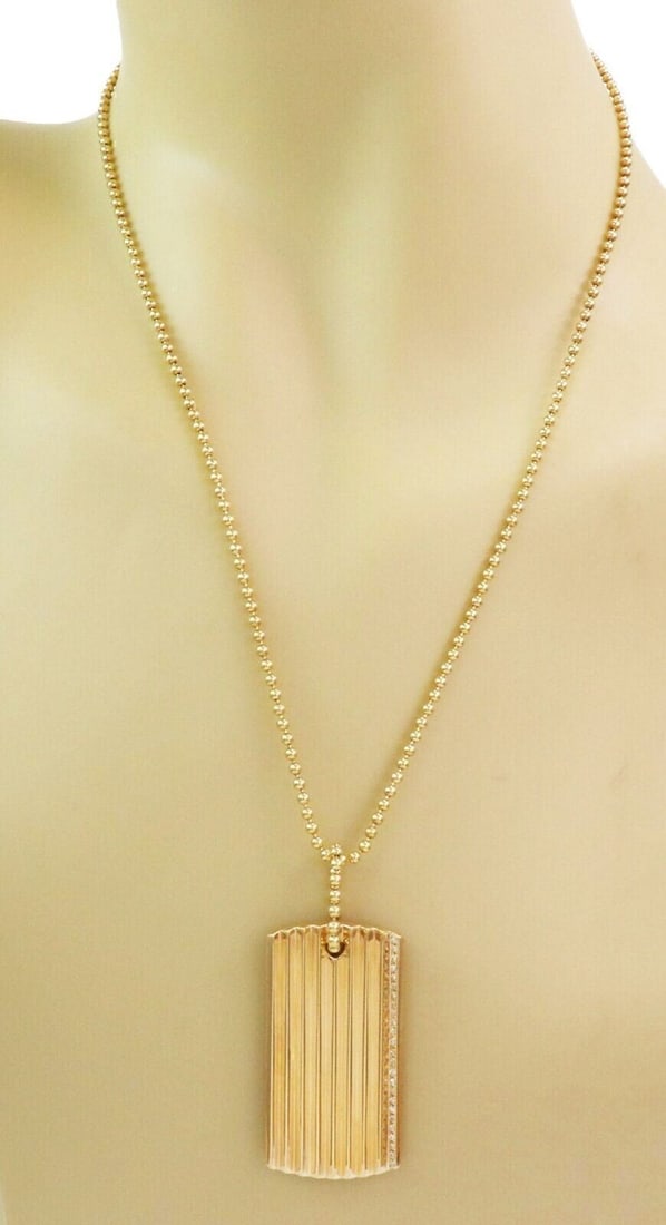 18k Yellow Gold Diamond ID Pendant Necklace Roberto Coin: 18k Yellow Gold Diamond ID Pendant Necklace Roberto Coin A pre-owned Roberto Coin diamond rectangular ID pendant necklace crafted in 18k yellow gold. The design features an elongated sculptural pendan