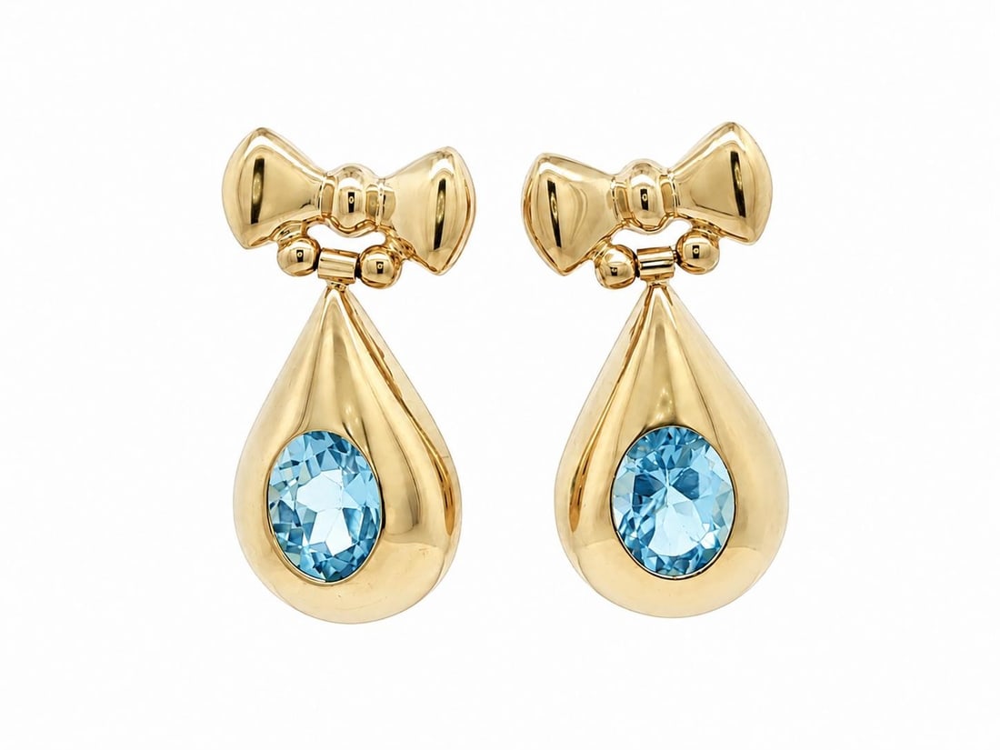 Unbranded 14k Yellow Gold Bow Drop Earrings with Oval Blue Topaz 4.6ctw: Unbranded 14k Yellow Gold Bow Drop Earrings with Oval Blue Topaz 4.6ctw Vintage dangle drop earrings crafted in solid 14k yellow gold and set with two natural genuine oval blue topaz stones in a bow d