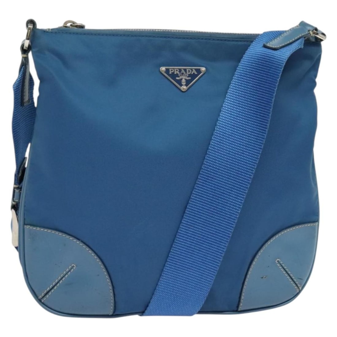 Prada Blue Nylon Shoulder Bag Silver Tone Hardware Made in Italy: Prada Blue Nylon Shoulder Bag Silver Tone Hardware Made in Italy A Prada shoulder bag made of blue nylon with silver-tone metal fittings. It is made in Italy and measures approximately 26 cm W x 24 cm