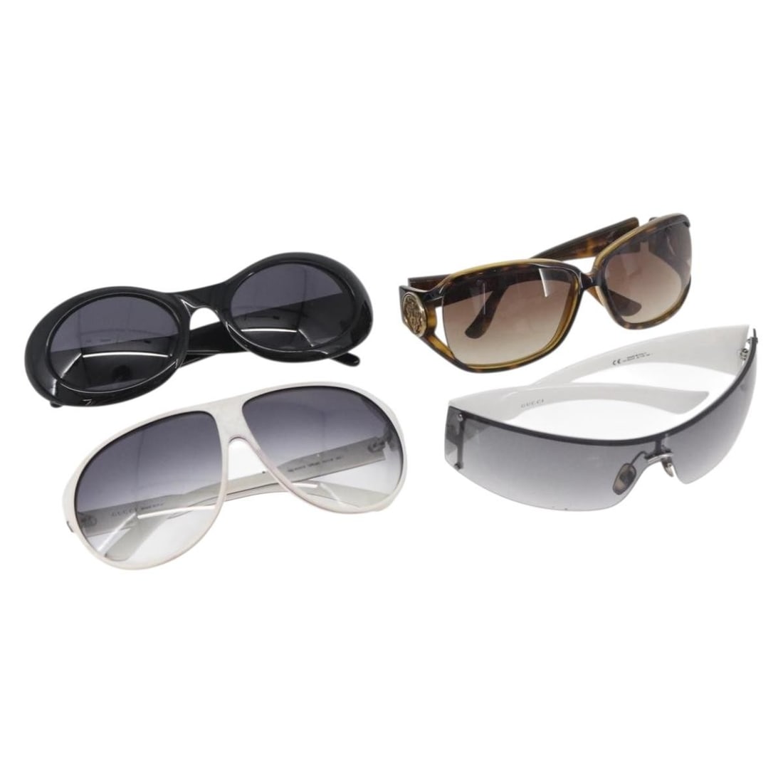 Gucci plastic sunglasses set in black white brown with case: Gucci plastic sunglasses set in black white brown with case This is a set of four GUCCI women's sunglasses in black, white, and brown, crafted from plastic. Made in Italy, each pair features the iconi
