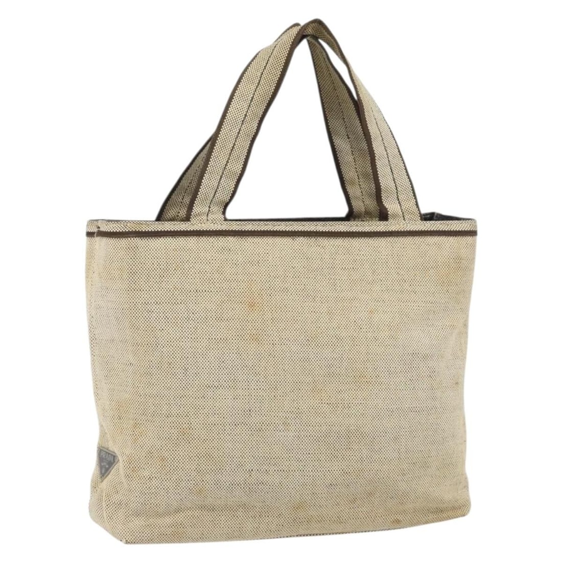 Beige and Silver Canvas PRADA Handbag Made in Italy: Beige and Silver Canvas PRADA Handbag Made in Italy This PRADA handbag features a beige and silver canvas exterior and is crafted in Italy. The bag includes dual top handles and offers a compact size 