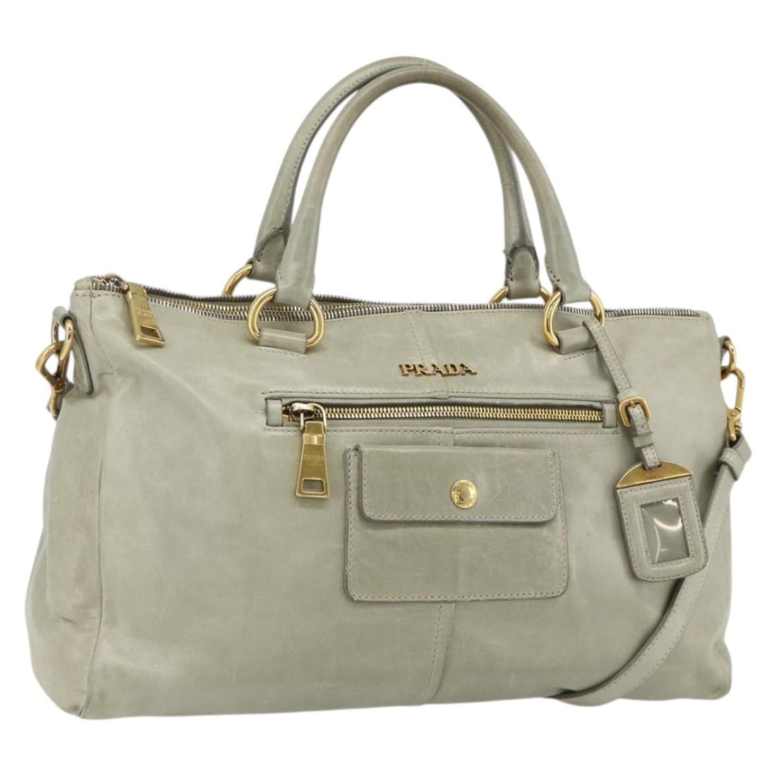 Prada gray gold leather tote with shoulder strap: Prada gray gold leather tote with shoulder strap This PRADA 2-way handbag is crafted from leather in a sophisticated gray and gold color combination. Designed for versatility, it can be carried by han