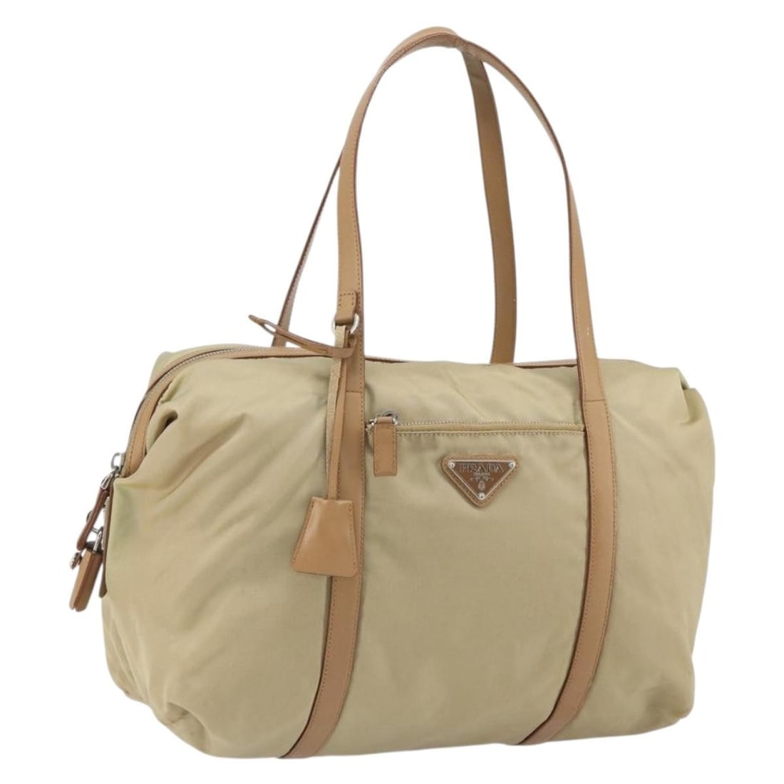 Beige Nylon Tote with Silver Accents and Accessories by Prada: Beige Nylon Tote with Silver Accents and Accessories by Prada This PRADA tote bag features a beige nylon exterior with silver-tone accents. Designed with practicality in mind, it includes a spacious i