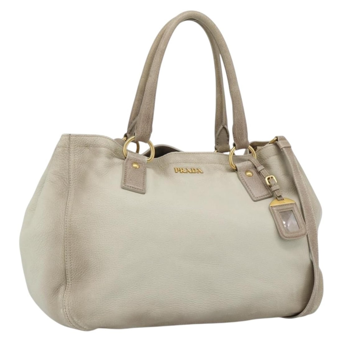 PRADA beige leather 2way tote bag with shoulder strap: PRADA beige leather 2way tote bag with shoulder strap This PRADA tote bag is crafted in beige leather and made in Italy. It features a two-way design with a shoulder strap and handle, and comes with a