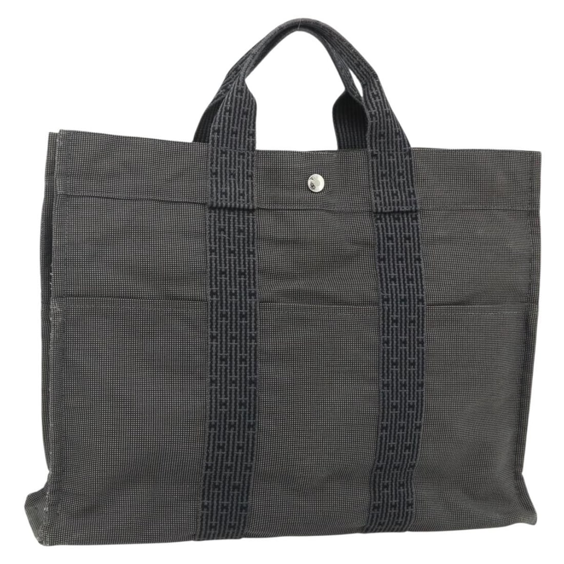 Hermes Her Line MM Gray Canvas Hand Bag Silver Tone: Hermes Her Line MM Gray Canvas Hand Bag Silver Tone A Hermes Her Line MM hand bag in gray and silver canvas, made in France. This item is listed as a hand bag and is offered in heavily used condition 