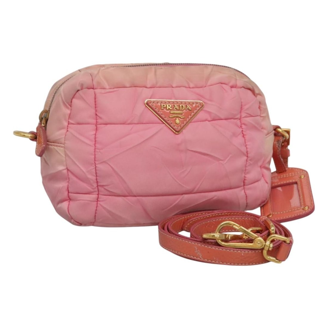 Prada Pink Gold Nylon Shoulder Bag with Name Tag Italy: Prada Pink Gold Nylon Shoulder Bag with Name Tag Italy This PRADA shoulder bag is crafted from pink and gold nylon and features a compact, structured silhouette. Designed for women, it includes an adj