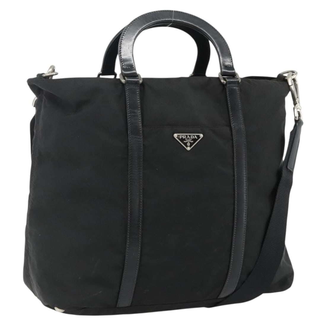 Prada Black Nylon 2 Way Handbag with Shoulder Strap Silver Tone: Prada Black Nylon 2 Way Handbag with Shoulder Strap Silver Tone A Prada 2way handbag in black and silver, made from nylon and presented in a handbag style. It comes with a shoulder strap and was made 