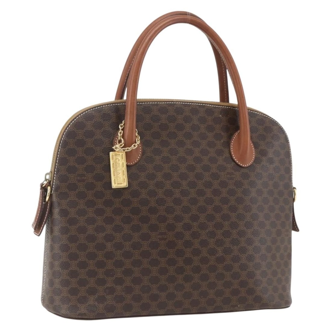 Celine Macadam Brown PVC Leather Handbag with Gold Tone Accents: Celine Macadam Brown PVC Leather Handbag with Gold Tone Accents This CELINE Macadam hand bag features a brown and gold exterior crafted from PVC leather and Macadam canvas. Made in Italy, the bag has 