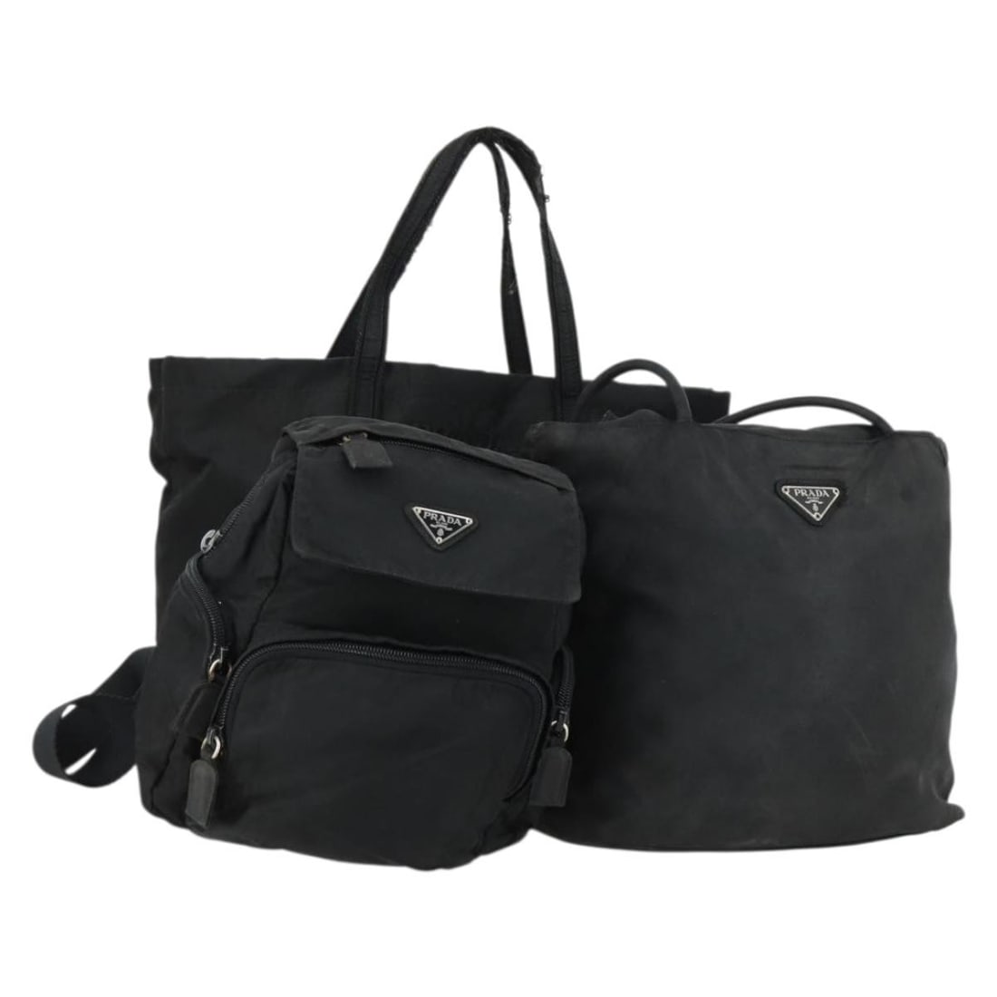 3 Piece Black Nylon Hand Bag Set PRADA Italy: 3 Piece Black Nylon Hand Bag Set PRADA Italy A black Prada nylon hand bag from Italy, offered as a special 3-piece set. The item is in heavily used condition, with visible wear including loss of shape