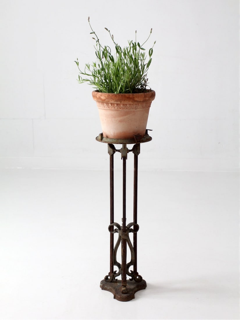 Victorian Gothic Revival Iron Fern Stand 27.5 inch: Victorian Gothic Revival Iron Fern Stand 27.5 inch Antique Gothic Revival iron plant stand with a tall architectural silhouette, pierced scrollwork, and a quatrefoil-inspired base. The elongated form 