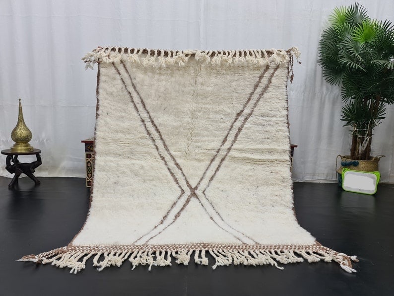 Authentic Moroccan Handmade Wool Rug with Geometric Pattern 9.84 x 6.56 ft: Authentic Moroccan Handmade Wool Rug with Geometric Pattern 9.84 x 6.56 ft Experience the elegance of this authentic soft white handmade Moroccan wool rug, featuring a beautifully engraved brown geome
