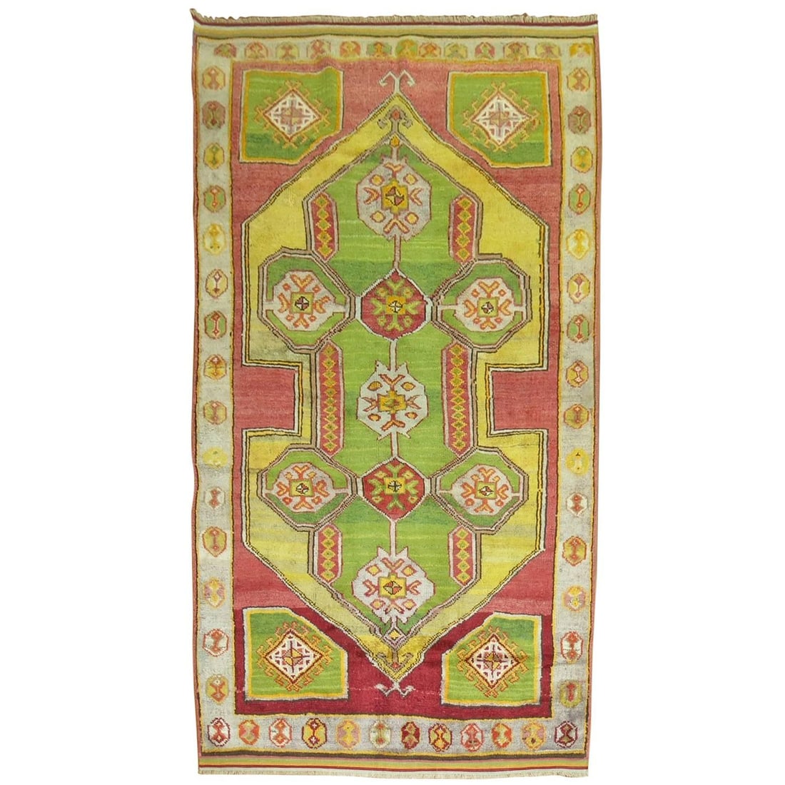 Hand Woven Wool Turkish Konya Rug Apple Green: Hand Woven Wool Turkish Konya Rug Apple Green This mid-20th century Turkish Konya carpet showcases a vibrant apple green hue, complemented by a mustard medallion, a red ground, and a gray border. Hand
