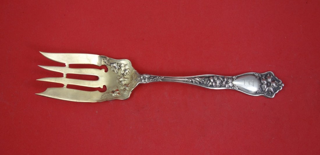 International Althea Sterling Silver Gold Washed Serving Fork 7 1/4: International Althea Sterling Silver Gold Washed Serving Fork 7 1/4 This is a sterling silver cold meat fork in the Althea pattern by International, featuring a gold washed finish. Measuring 7 1/4 inc