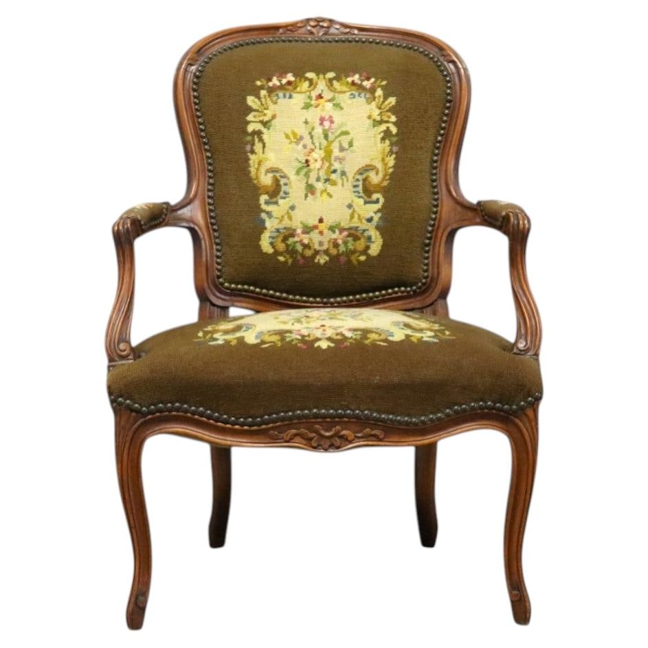 Carved Walnut Fauteuil Armchair in Louis XV Style with Needlepoint c1920: Carved Walnut Fauteuil Armchair in Louis XV Style with Needlepoint c1920 An antique French Louis XV style fauteuil armchair dating to approximately 1920, crafted from carved walnut. It features a clas